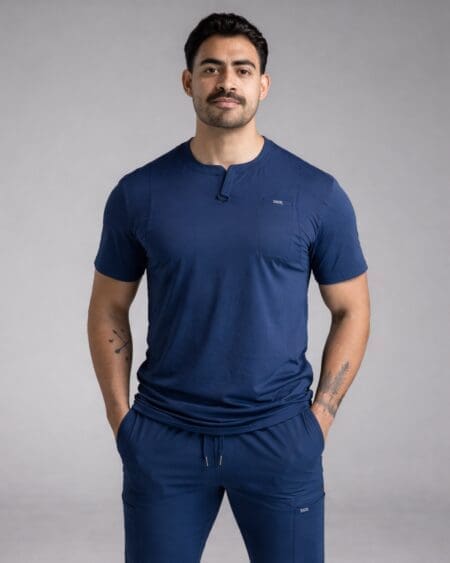 Person wearing navy scrubs, hands in pockets